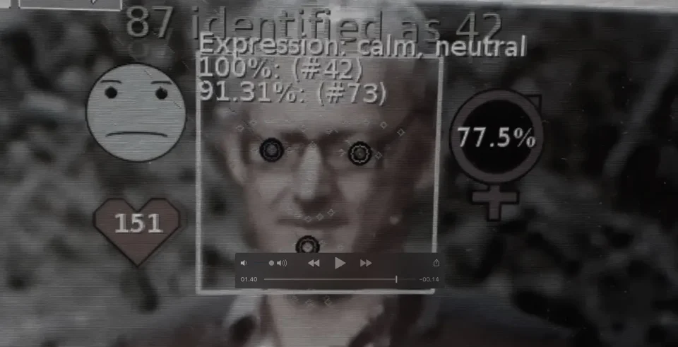 Film still; machine-vision system interface overlaid on debate participants.